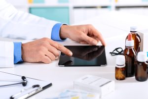 Physician working via a digital tablet to provide digital therapeutics services